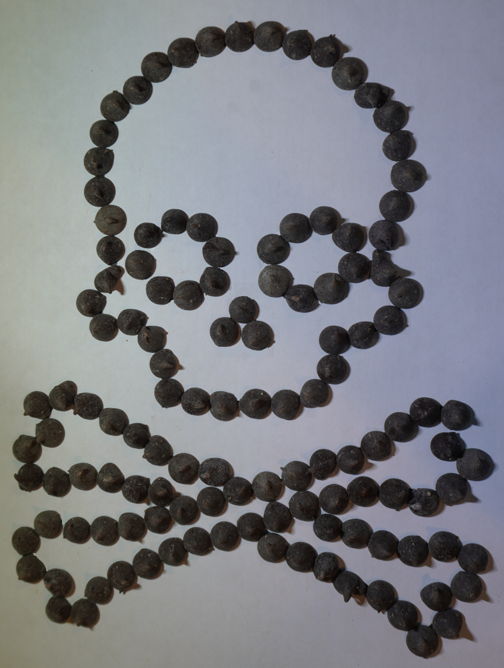 A skull and cross bones made of chocolate chips.